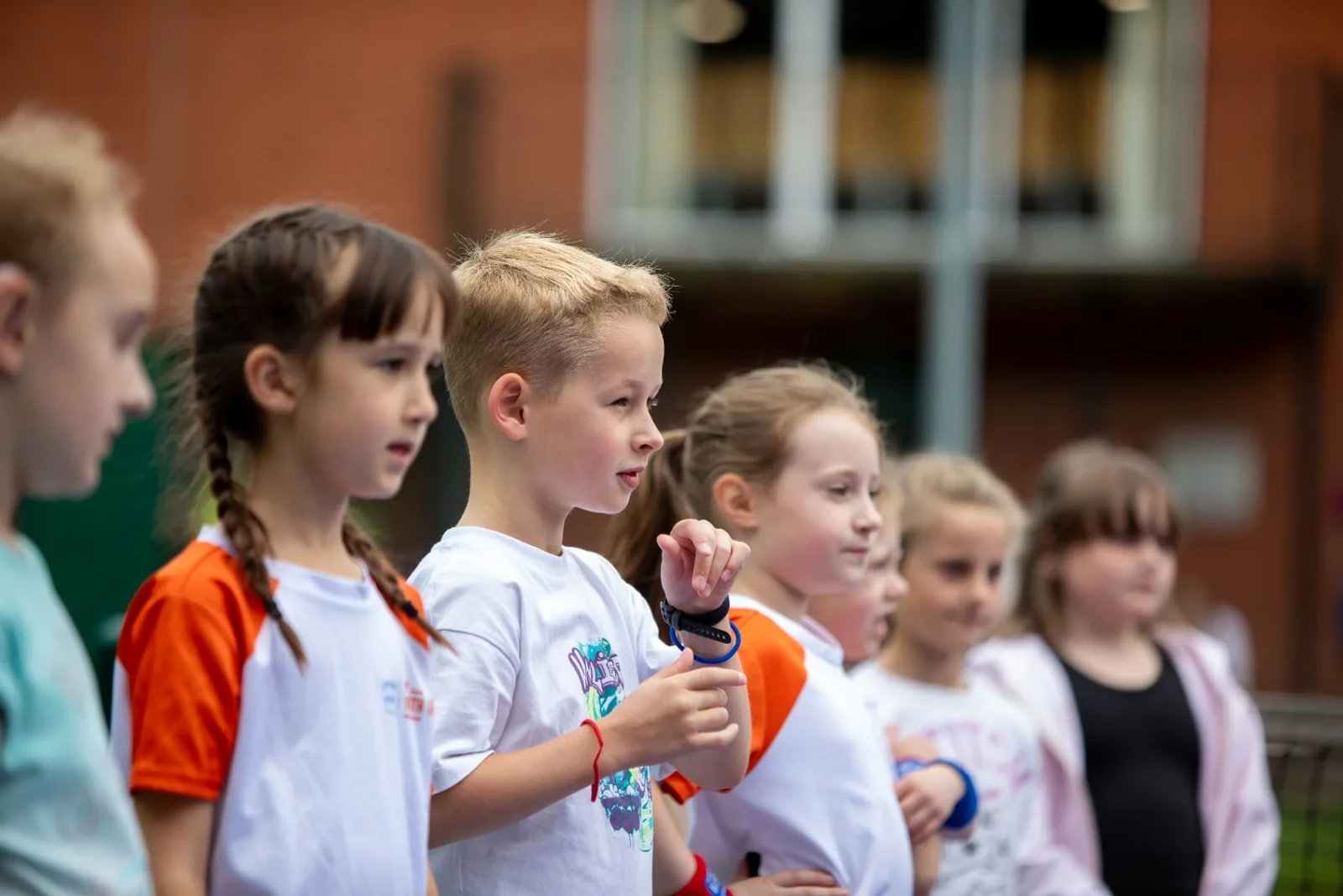Young tennis players listening together during a coaching session