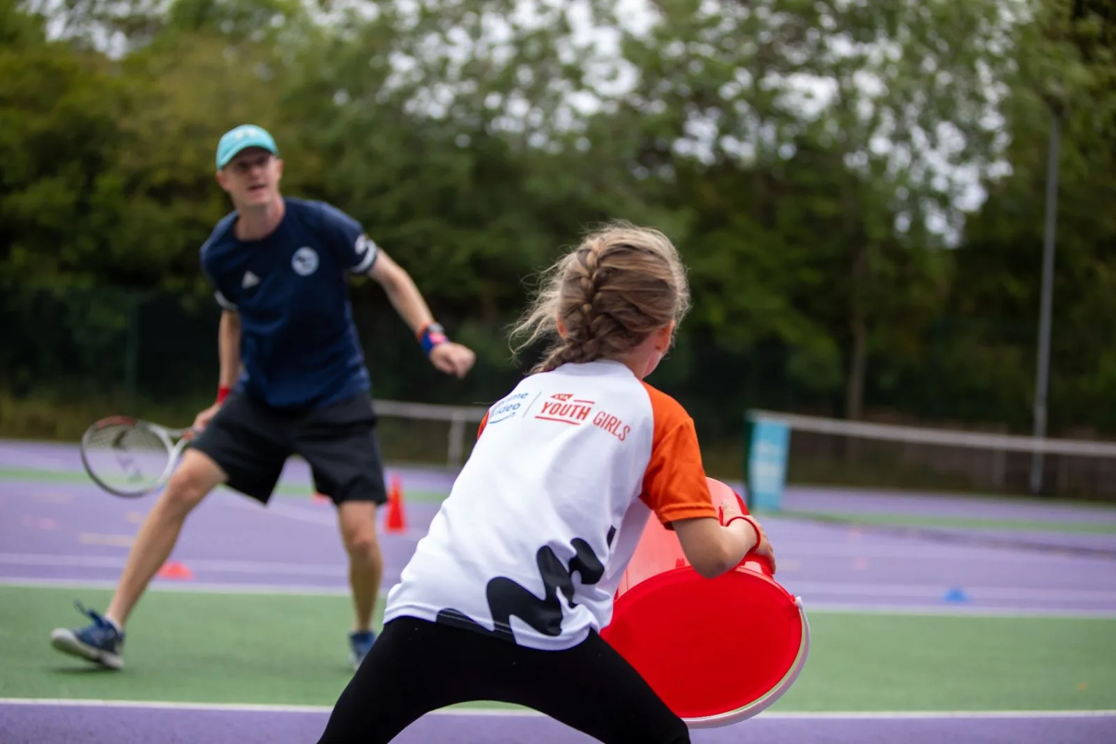Junior player hitting a forehand during a coached rally